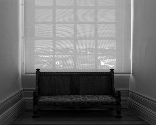 Peaceful person sitting by the window without gadgets